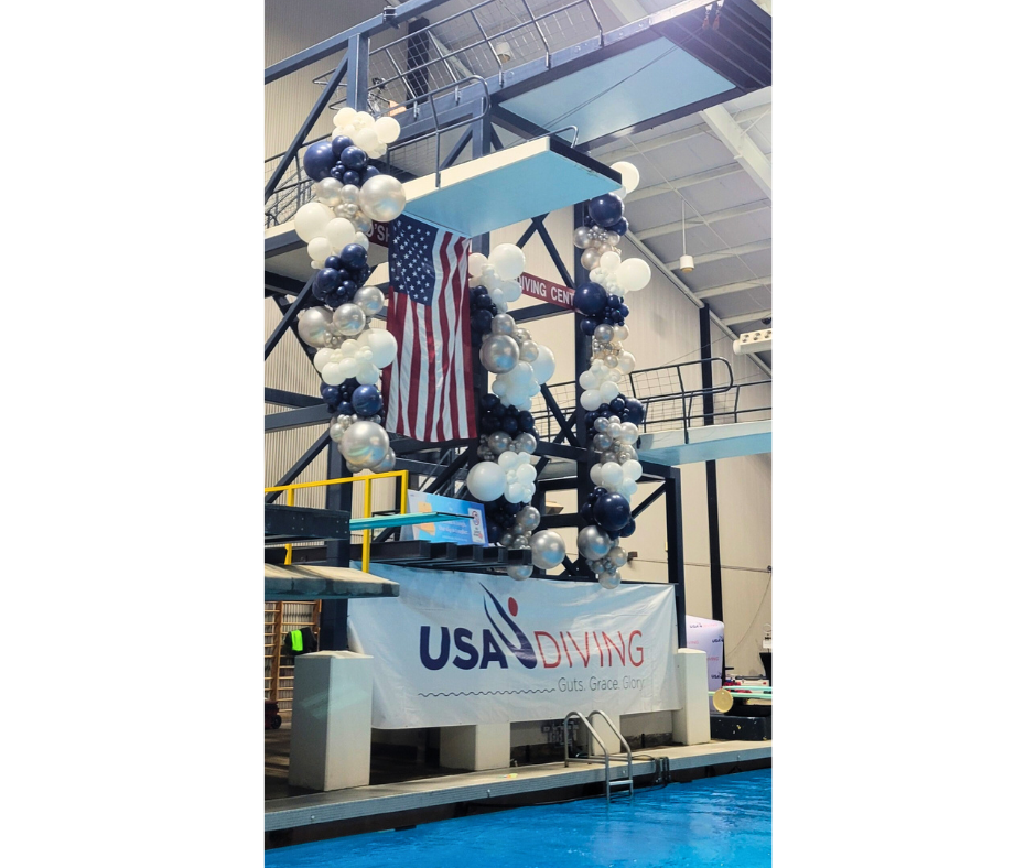 Diving platform decorated with balloons and American flag;