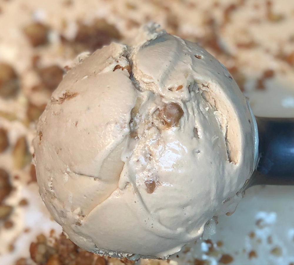 A close up of a scoop of ice cream on a table