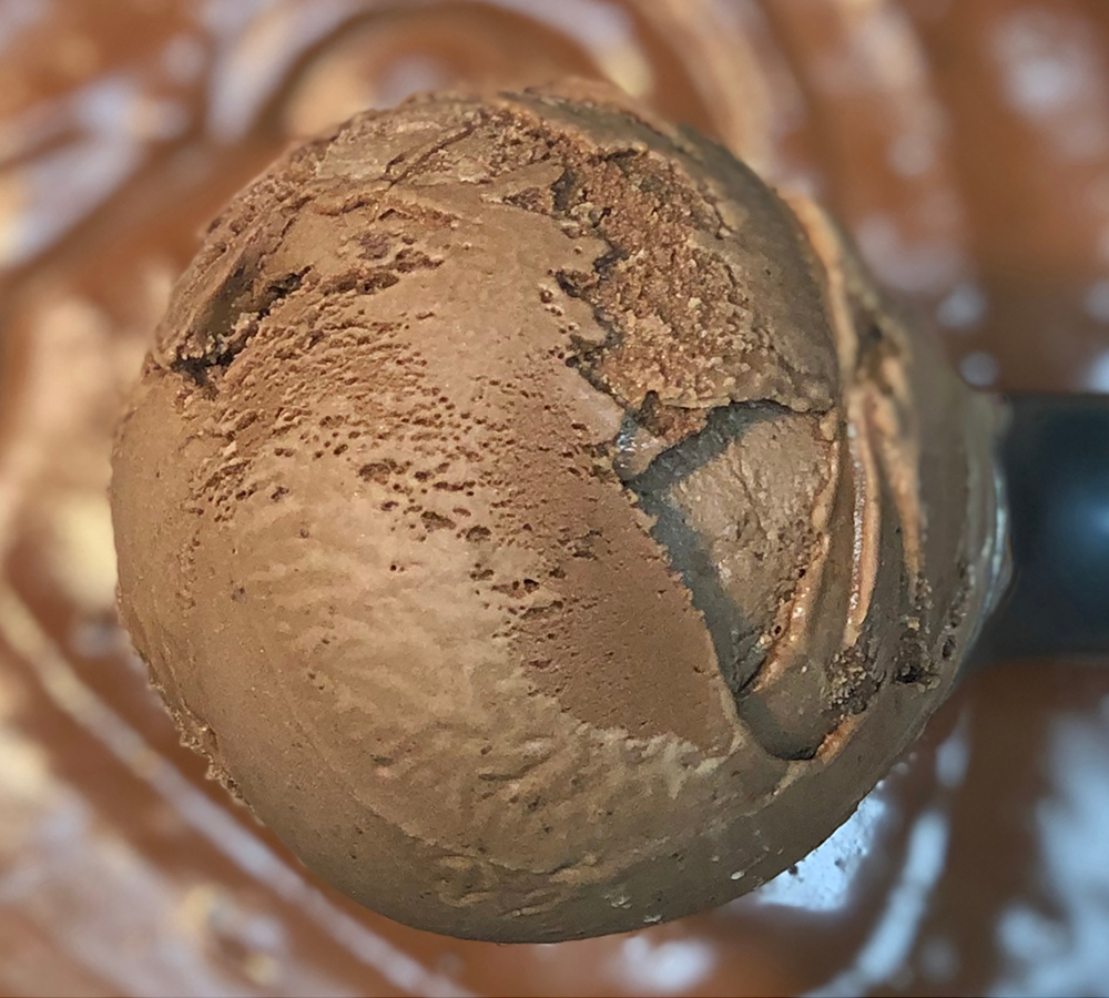 A close up of a scoop of ice cream on a table
