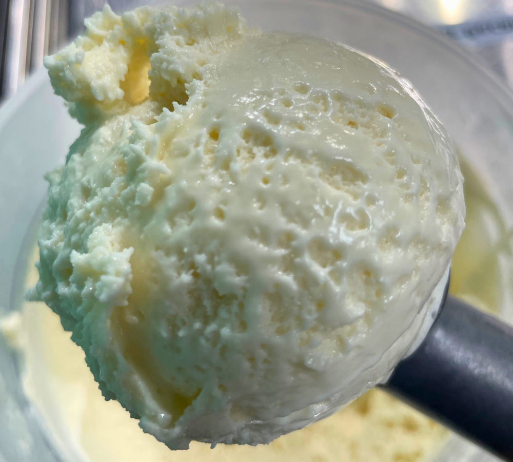 A close up of a scoop of ice cream on a table