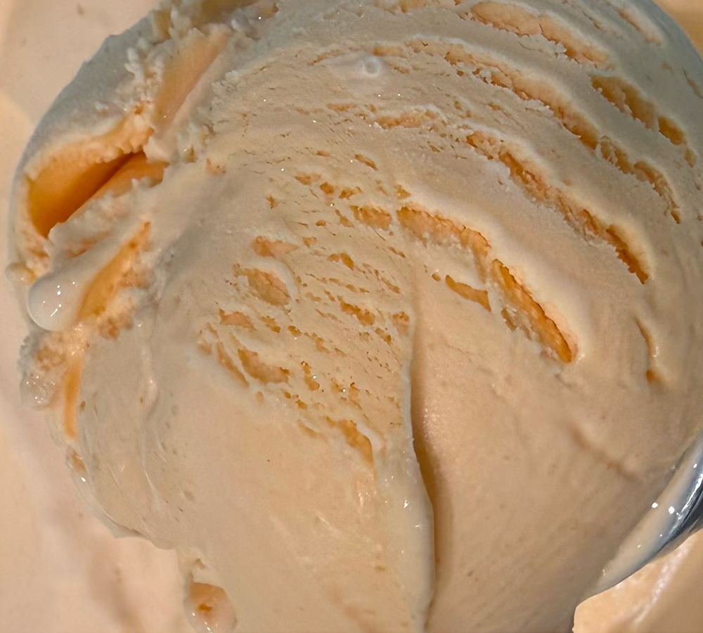 A close up of a scoop of ice cream on a table