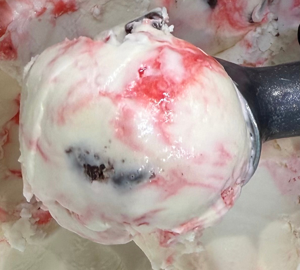 A close up of a scoop of ice cream on a table