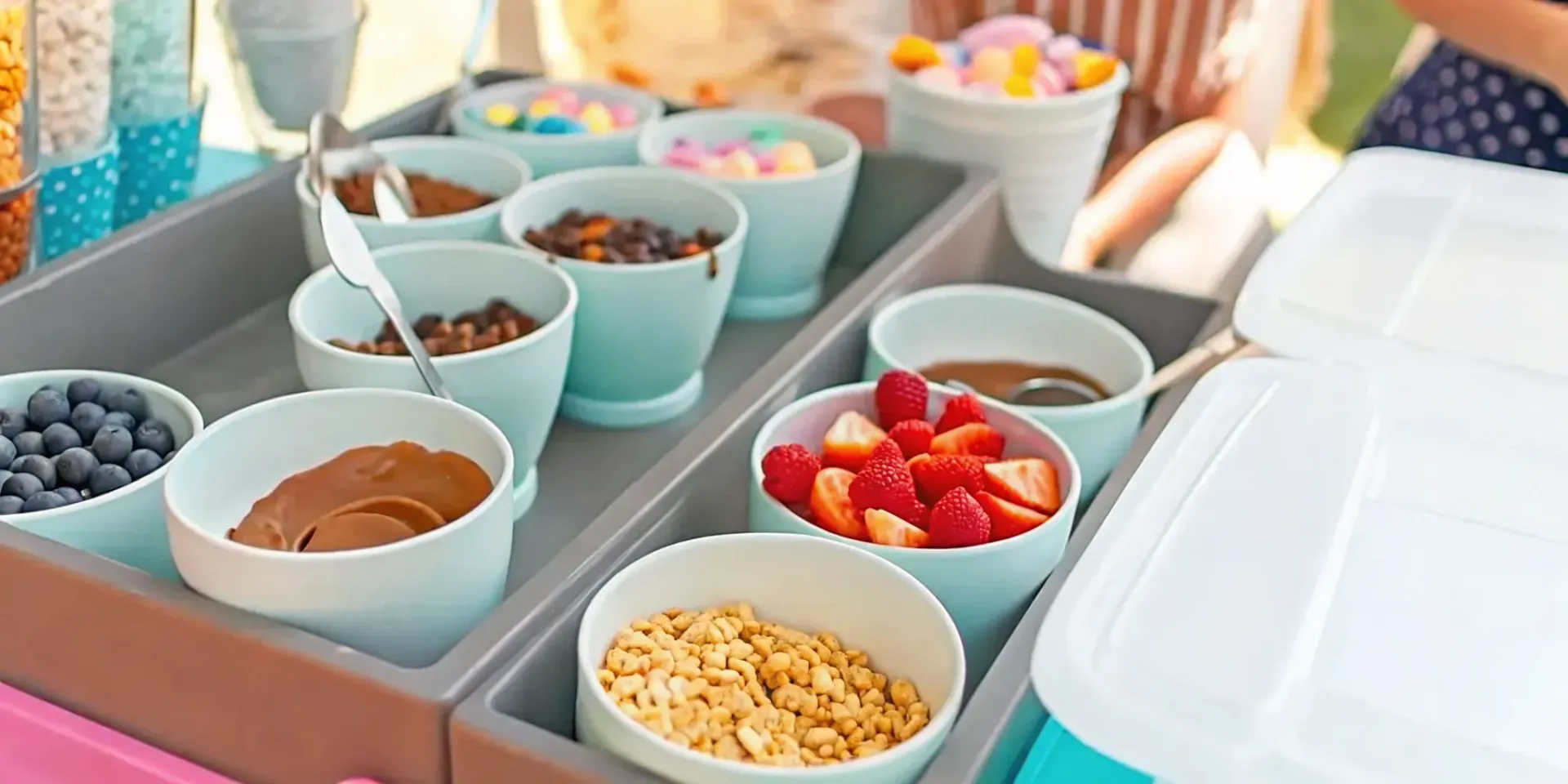 Ice cream sundae bar setup with colorful toppings in small bowls at a backyard party