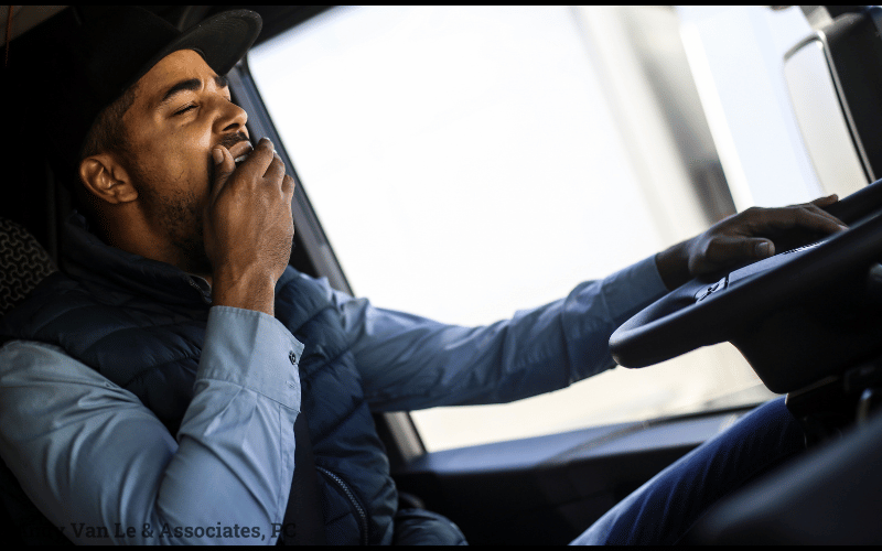driver looking tired yawning