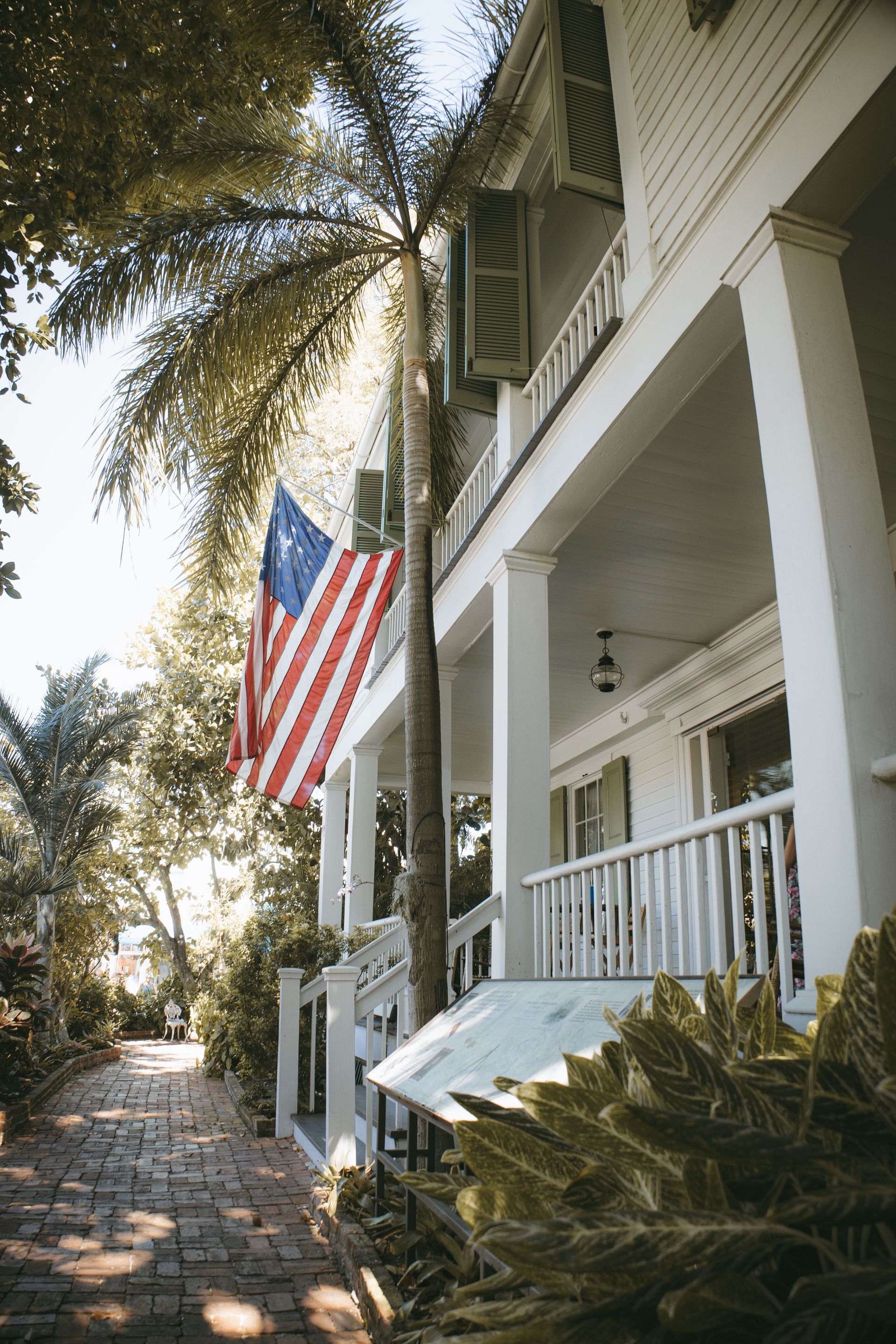 Front porch of a Florida home with an American flag in a Northeast Florida HOA neighborhood