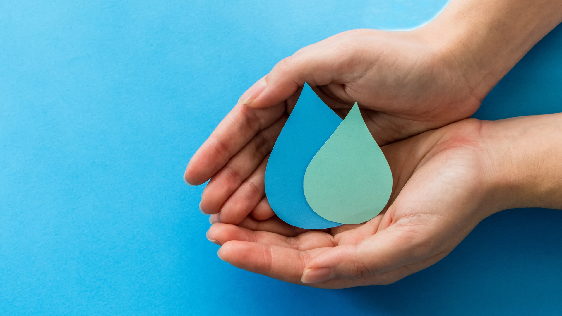Hands cupping a blue water droplet icon on a bright blue background