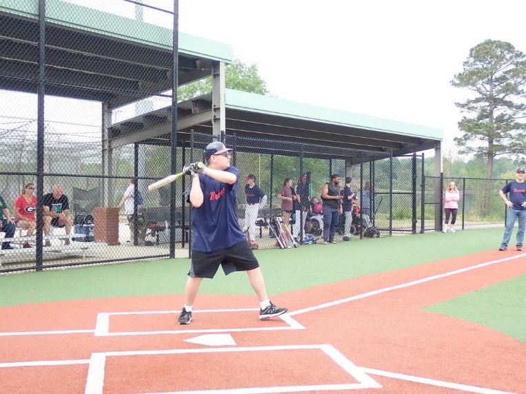A man is swinging a bat on a baseball field