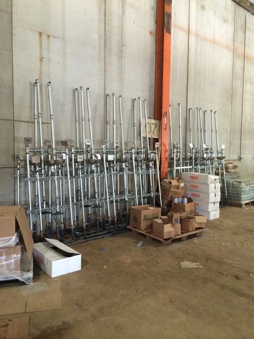 Under-construction plumbing with white pipes and dirt mounds inside a building.