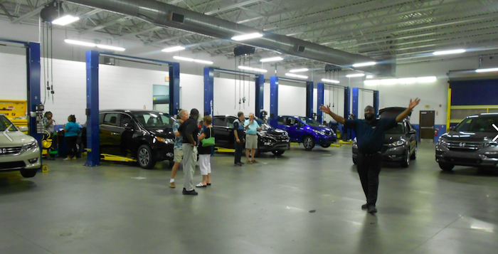 Stokes employees in the body shop with customers.