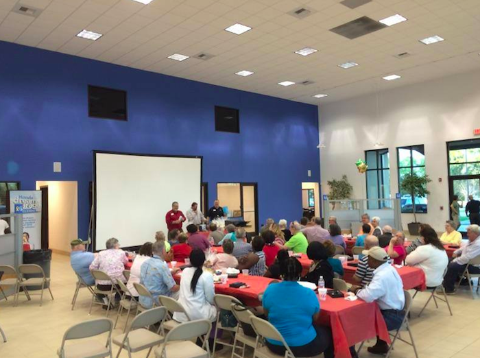 Stokes employees speaking with members of the community.