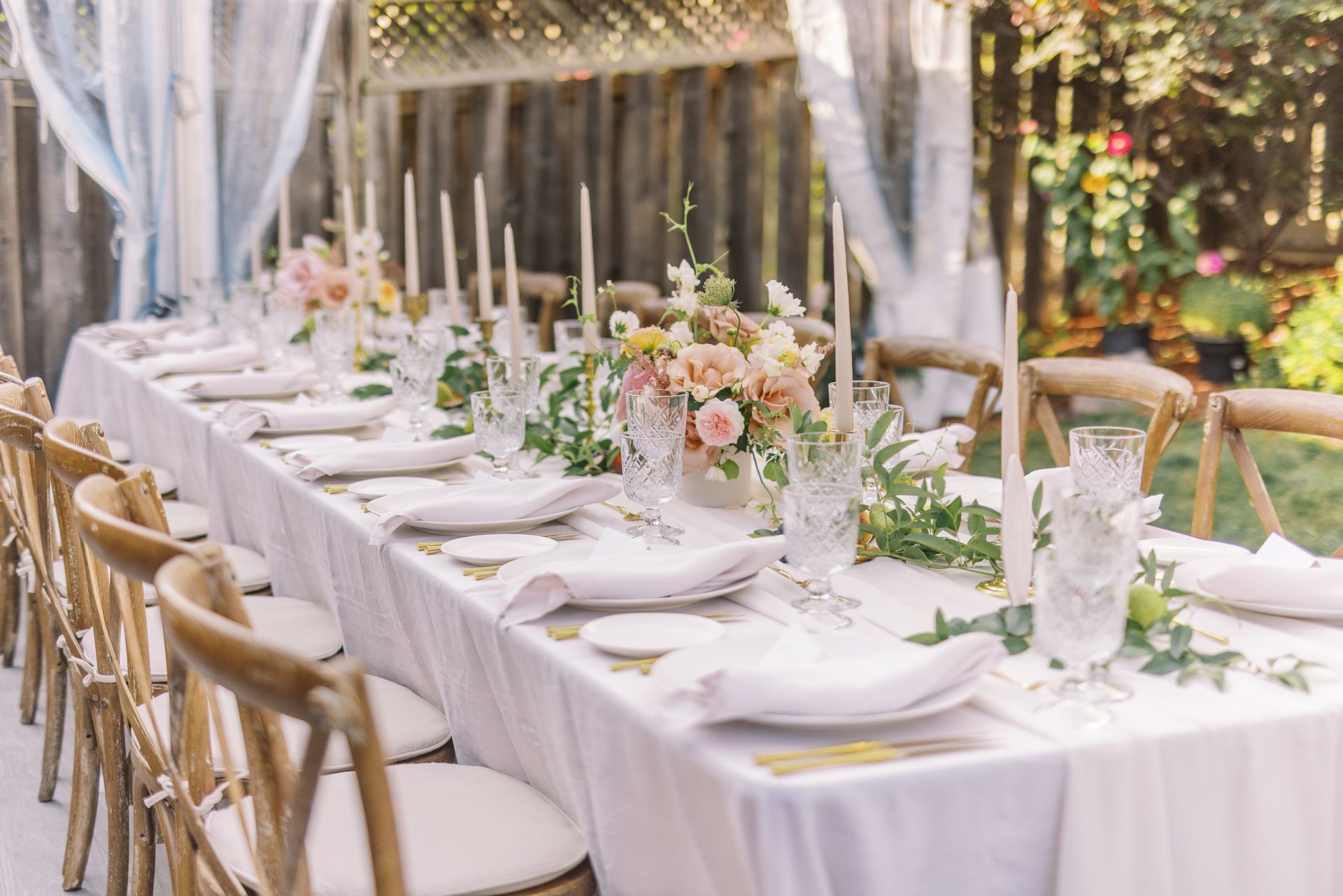 Long wooden table set for an outdoor event