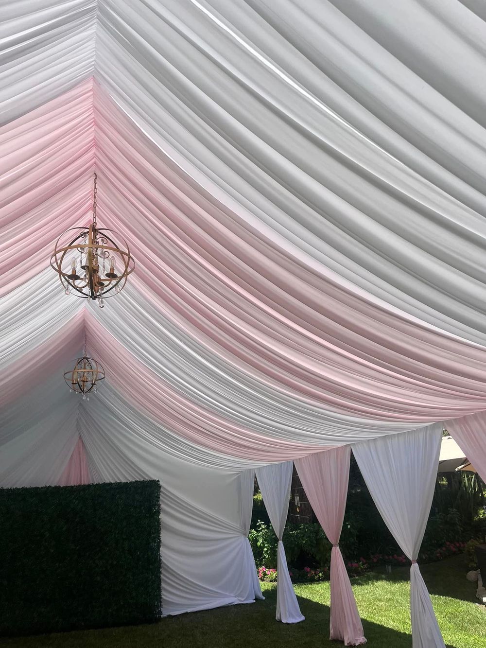 Pink and white draped fabric tent ceiling