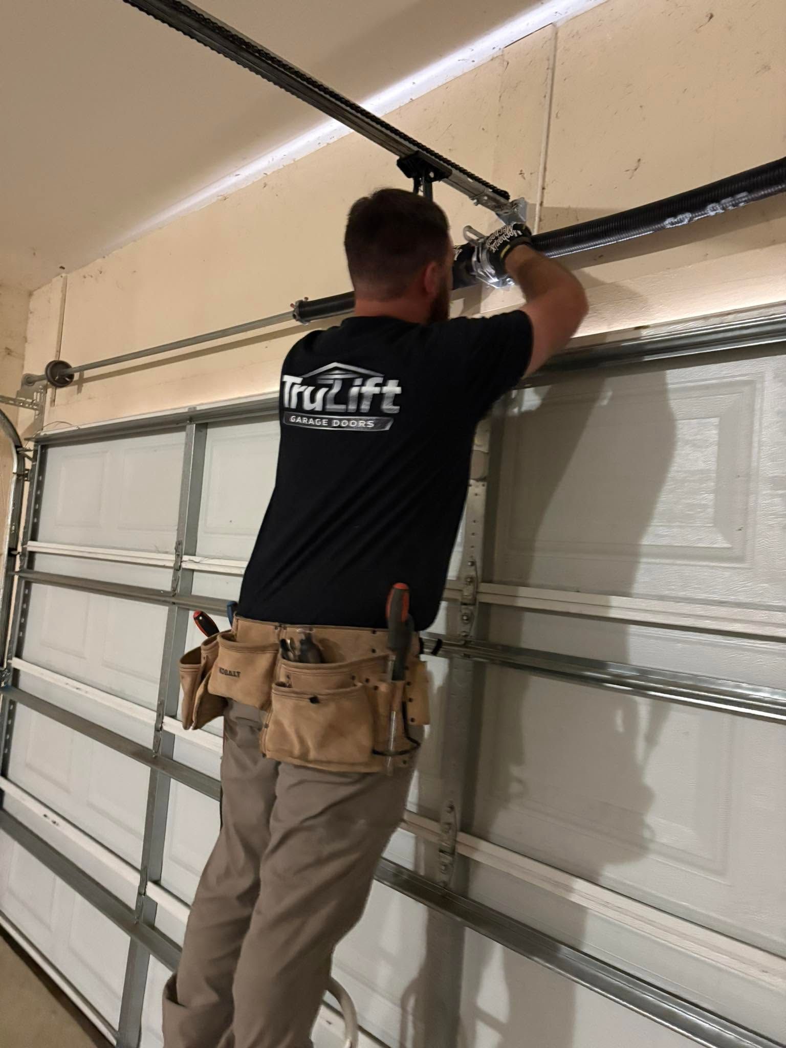 trulift garage doors technician servicing broken garage door spring
