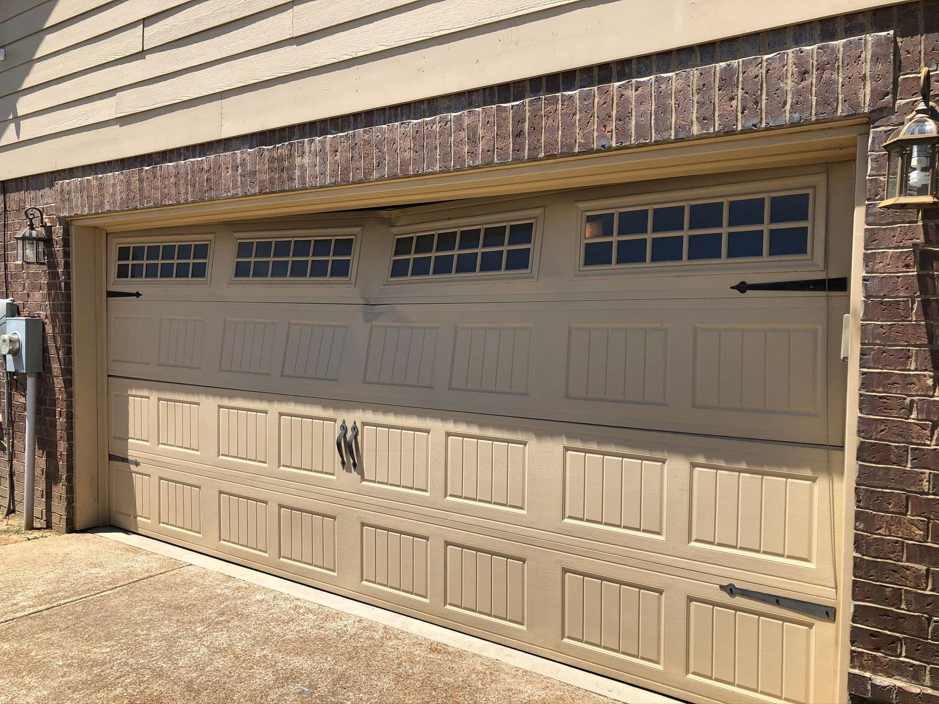 garage door with decorative hinges and windows