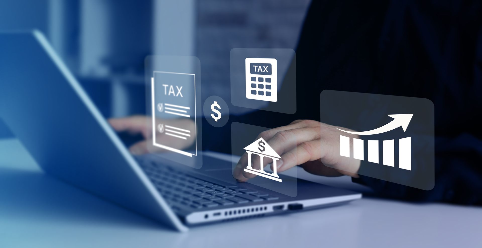 Laptop with finance icons, tax document, calculator, and rising bar chart over a hand typing on a keyboard