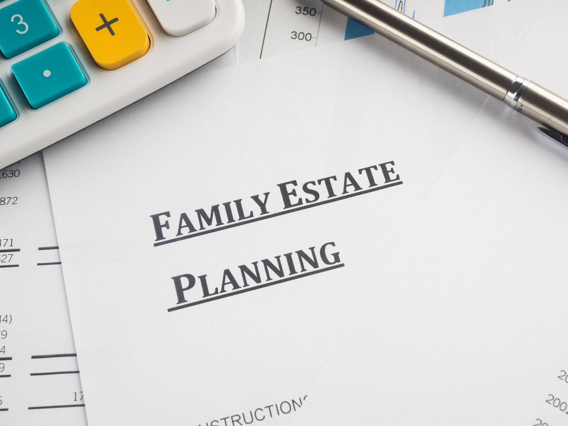 Family estate planning document with calculator and pen on a desk