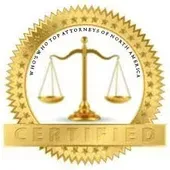 A gold seal with a scale of justice inside of it.