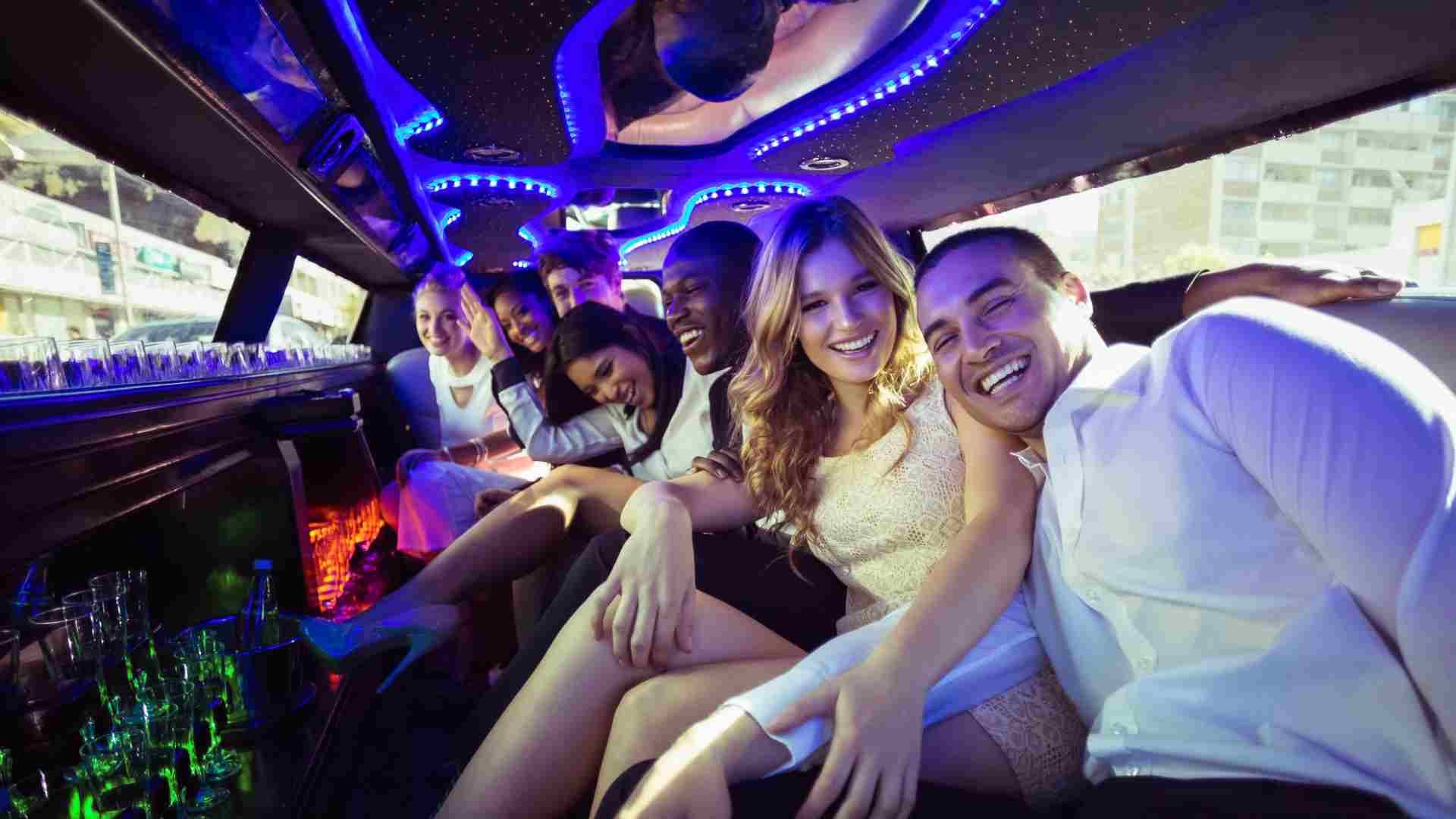 The inside of a limousine with purple lights on the ceiling