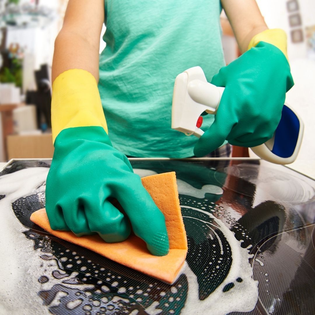 woman cleaning stove