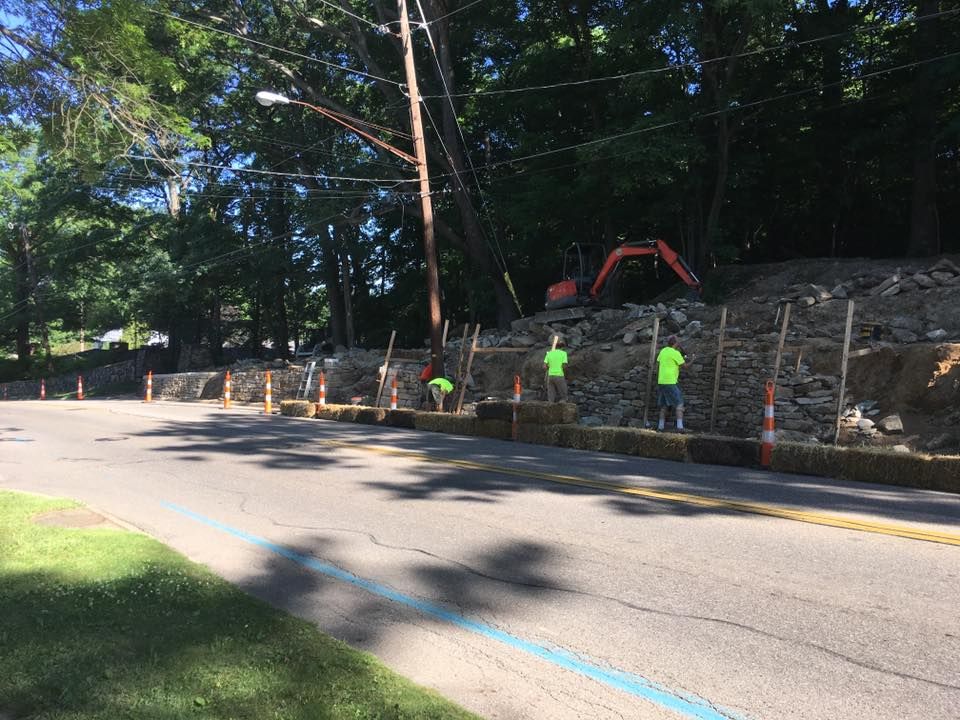 A group of construction workers are working on a road.