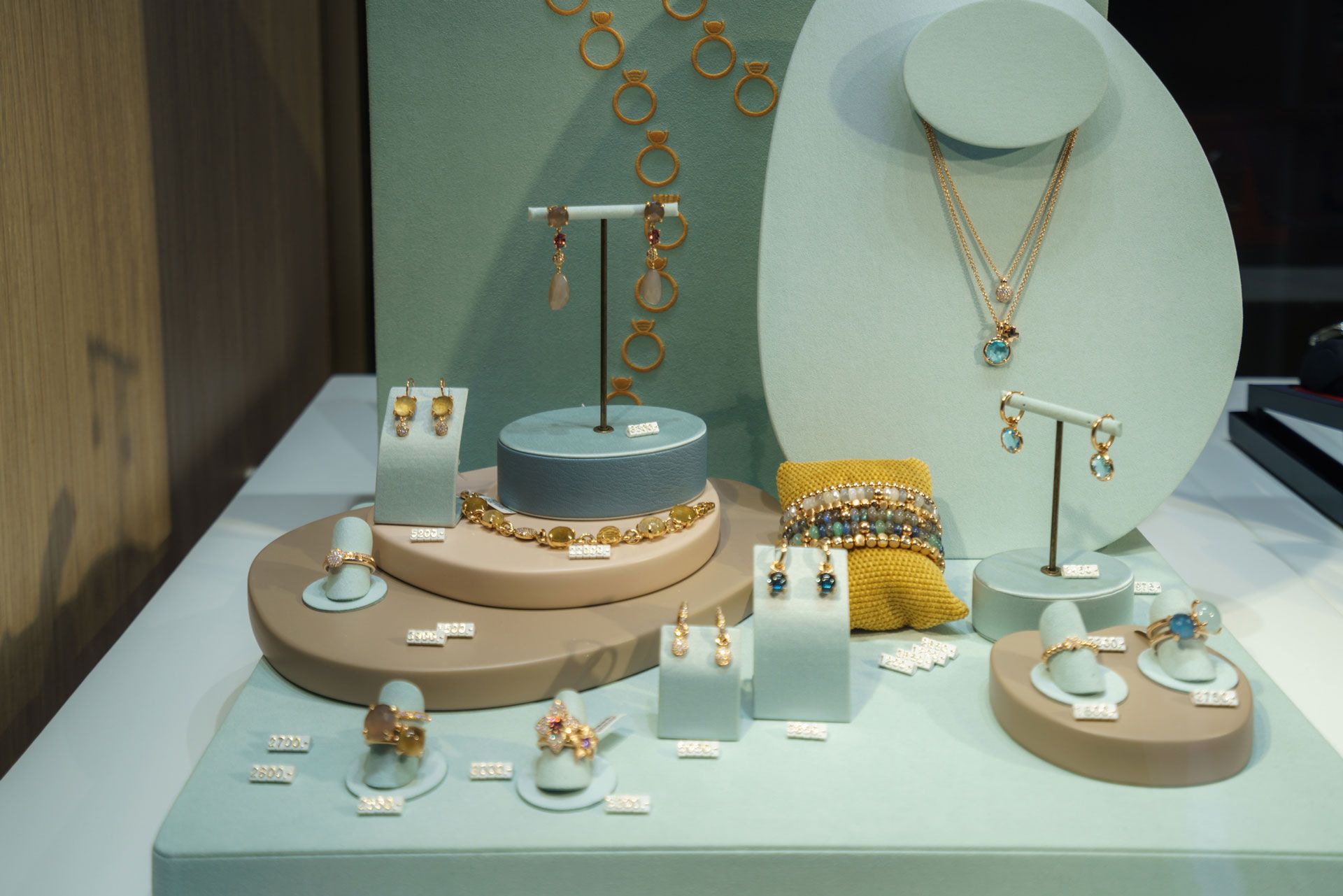 A display of jewelry including necklaces earrings and rings