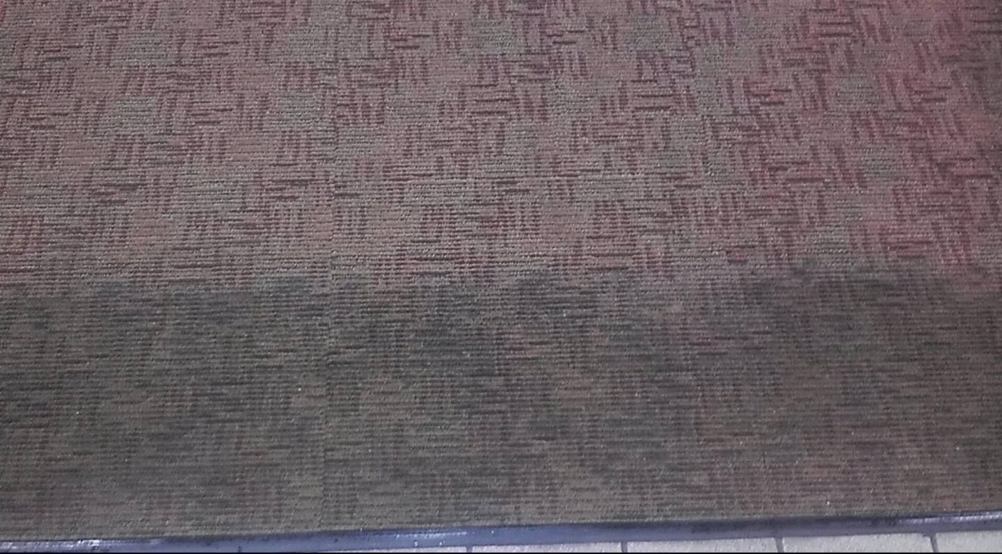 Close-up of a textured brown and gray fabric surface with a dark blue edge at the bottom.