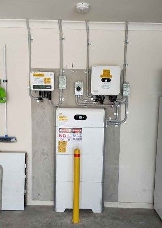 A garage with a lot of electrical equipment on the wall.