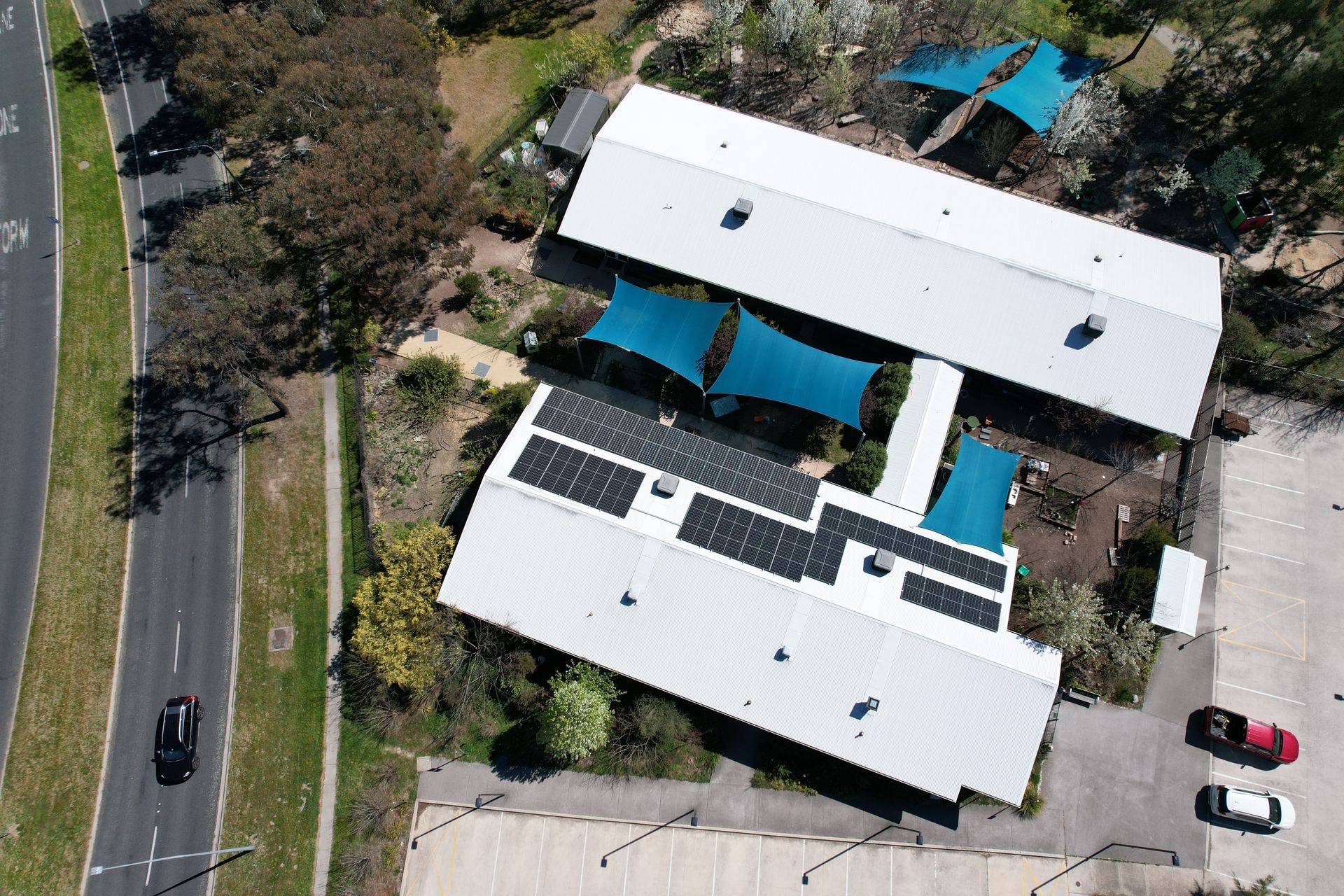 An aerial view of a building with solar panels on the roof