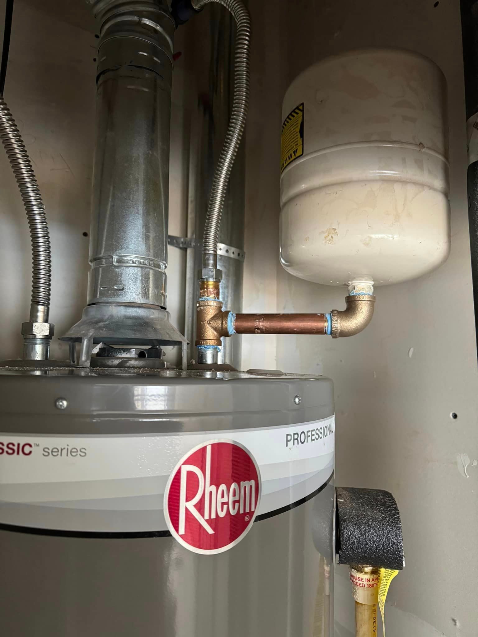 A rheem water heater with a tank attached to it.