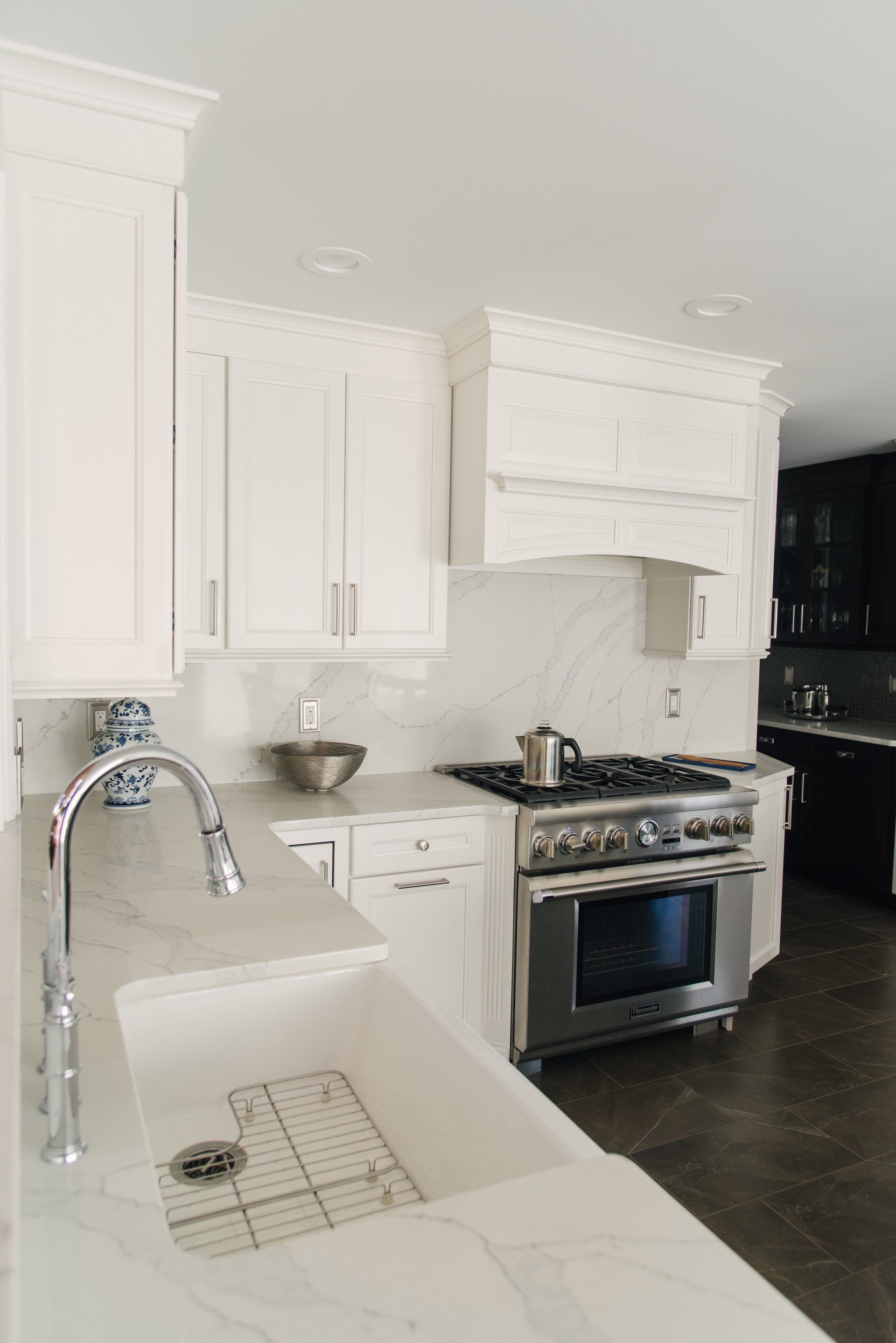 A kitchen with white cabinets and stainless steel appliances