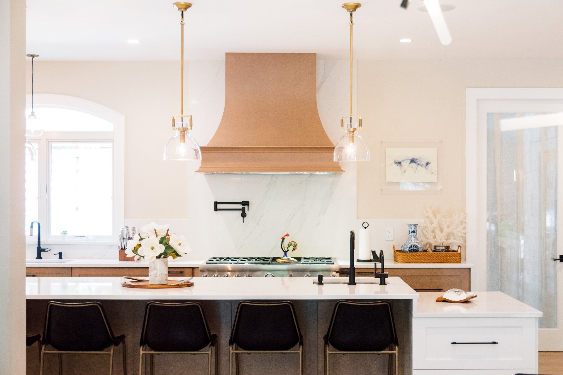 A kitchen with a large island and a stove top oven.