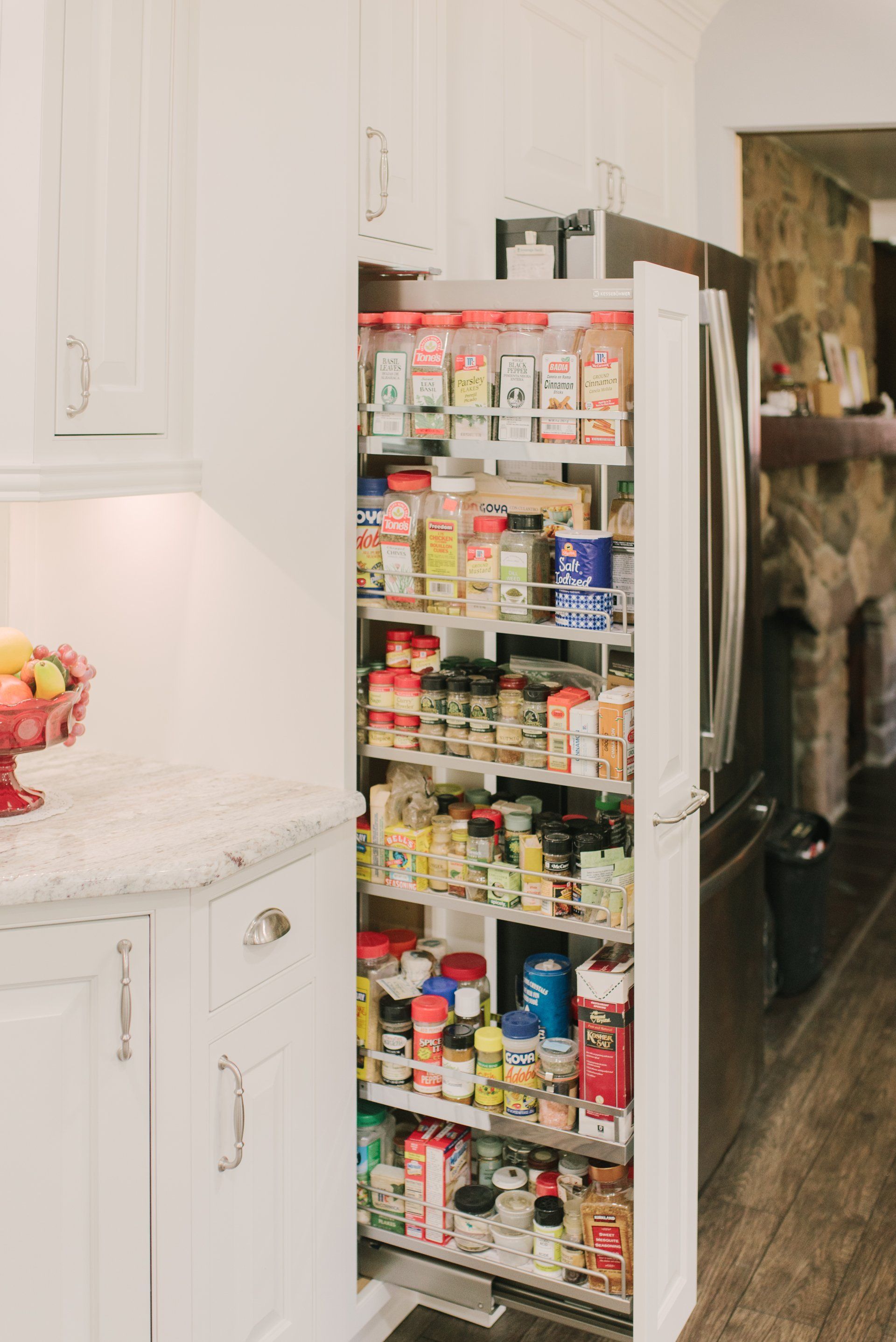 A pantry in a kitchen with a lot of food in it.