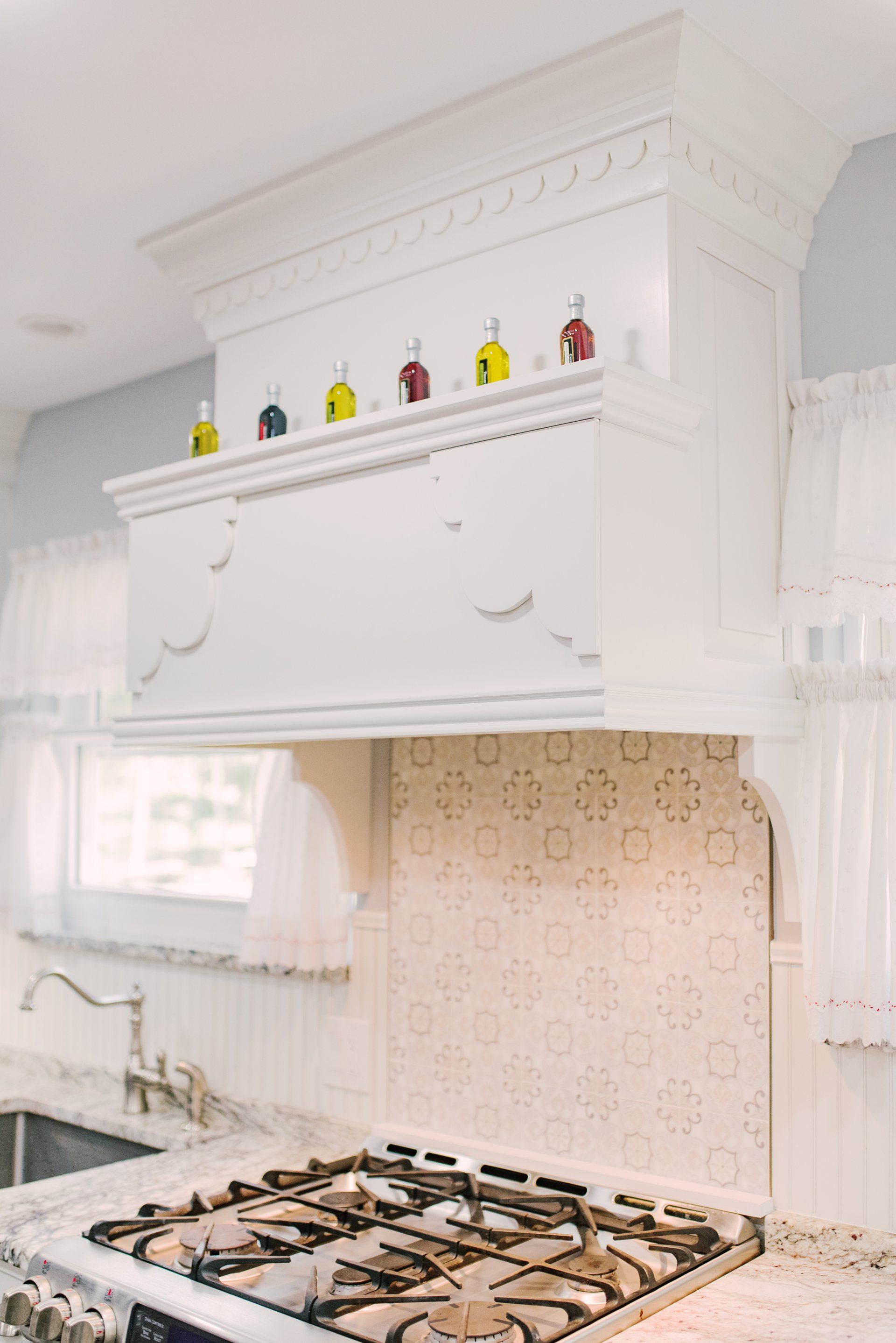 A kitchen with a stove top oven and a sink.