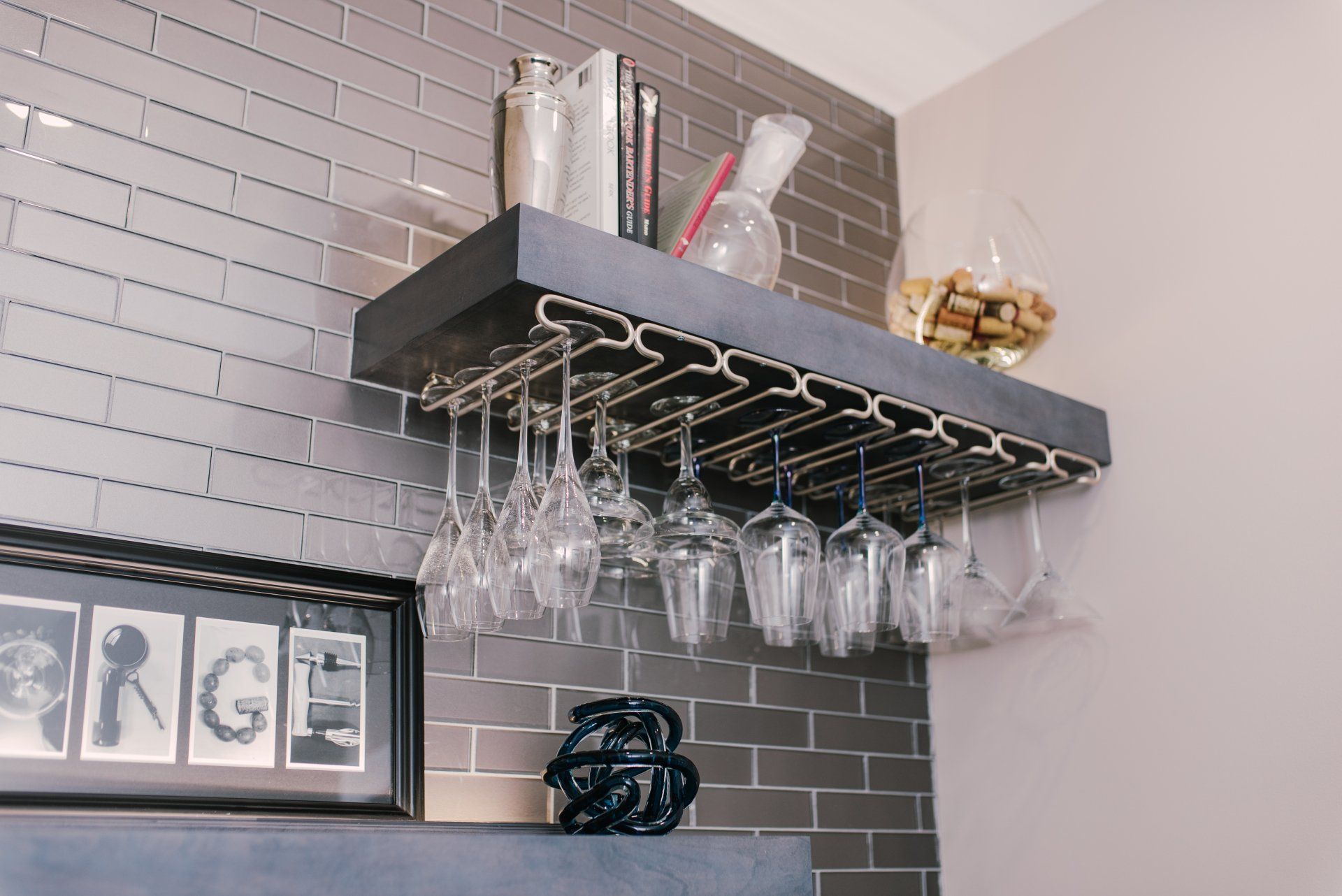 A shelf with wine glasses hanging from it and a sign that says garage