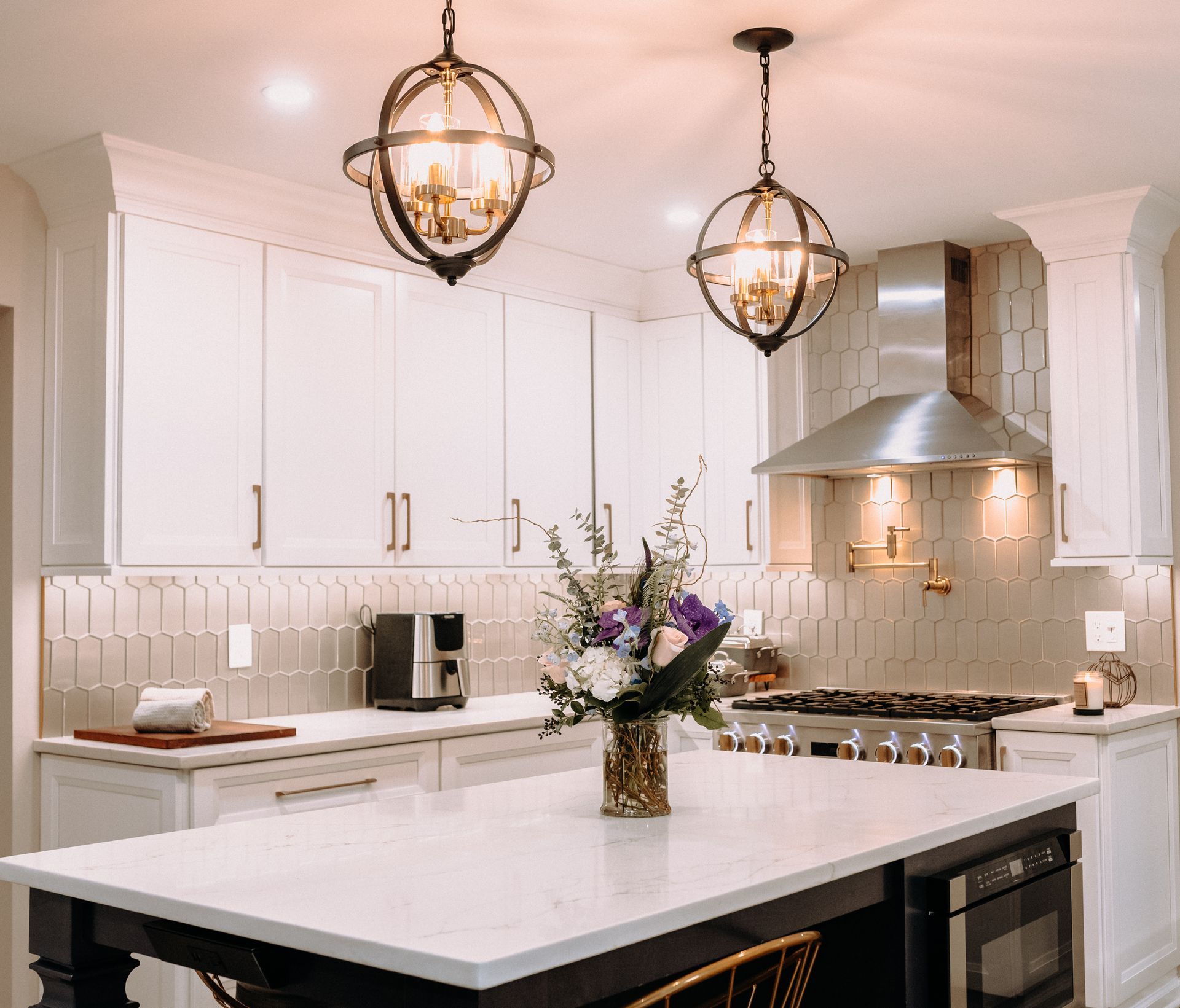 A kitchen with a vase of flowers on the counter