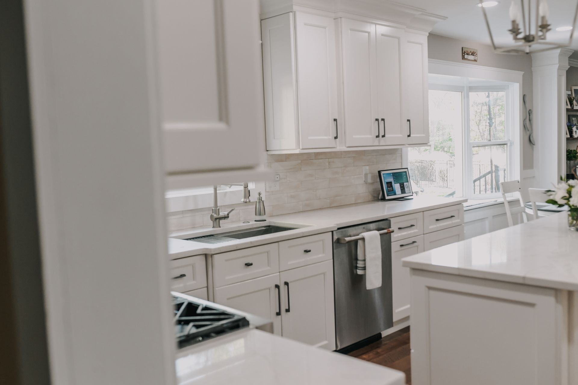 A kitchen with white cabinets and stainless steel appliances.
