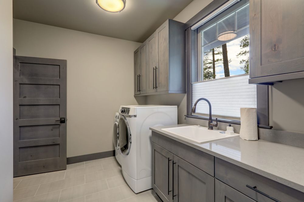 A Laundry Room With a Washer and Dryer and a Sink — Pacific Cabinets In Maclean, NSW