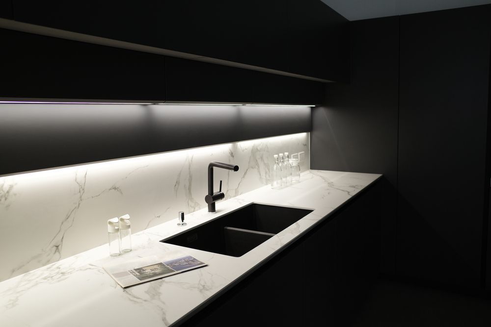 A Kitchen With a Black Sink and a White Counter Top — Pacific Cabinets In Iluka, NSW