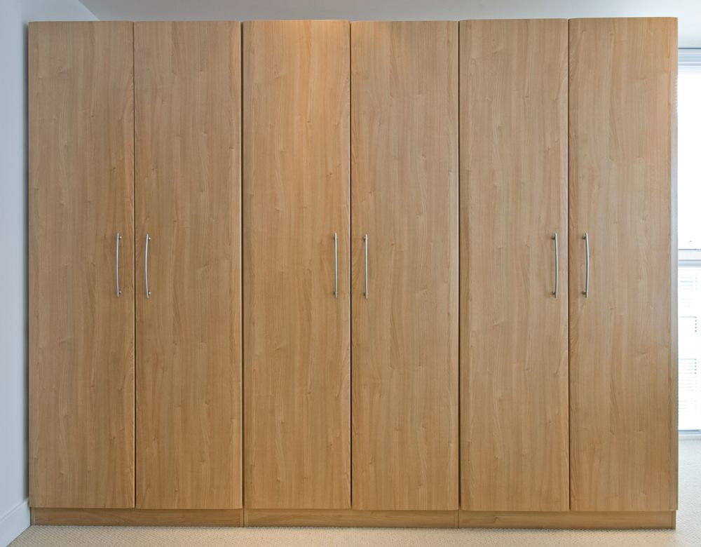 A Row of Wooden Cabinets With Handles in a Room — Pacific Cabinets In Yamba, NSW