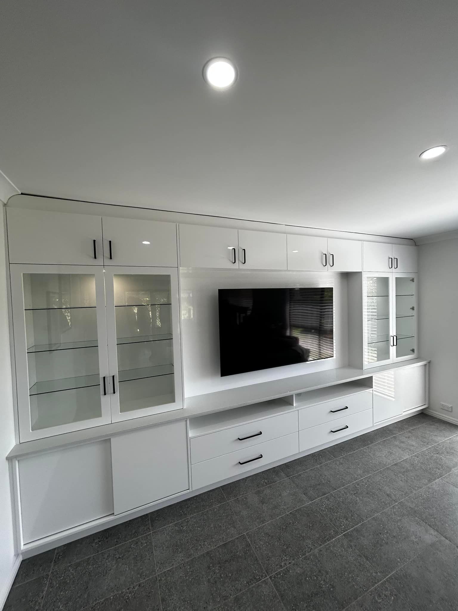 A Living Room With a Large Flat Screen Tv Mounted to the Wall — Pacific Cabinets In Yamba, NSW