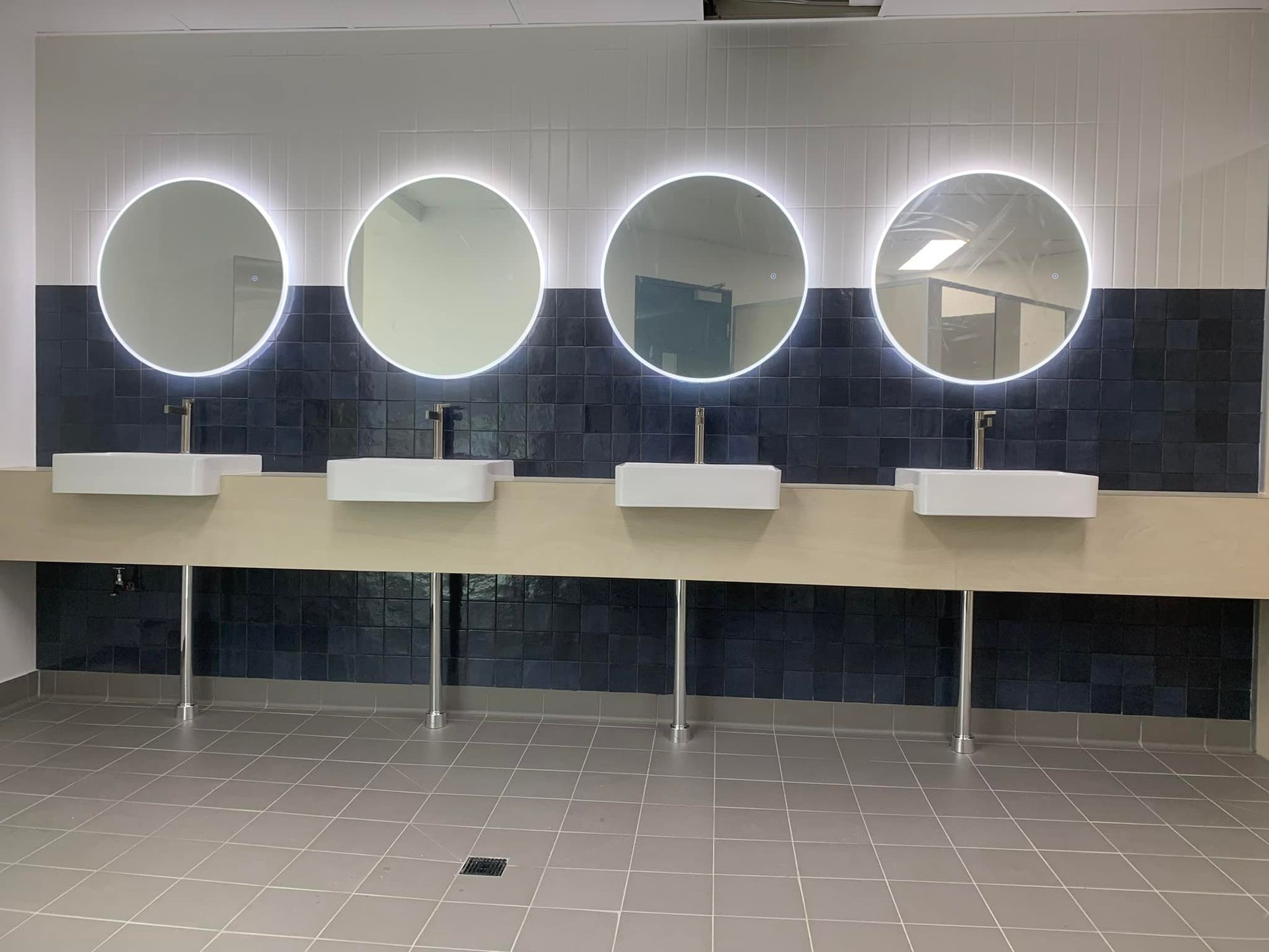 A Bathroom With a Row of Sinks and Mirrors — Pacific Cabinets In Maclean, NSW