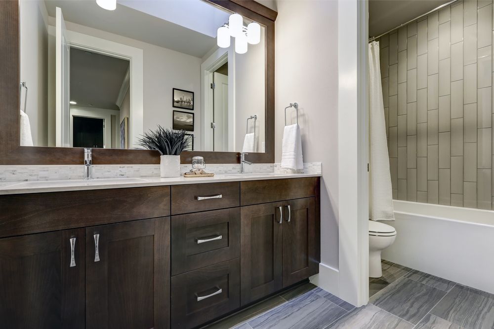 A Bathroom With Two Sinks , a Toilet , and a Large Mirror — Pacific Cabinets In Yamba, NSW