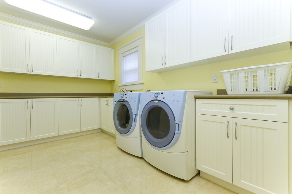 A Laundry Room With Two Washers and Two Dryers — Pacific Cabinets In Yamba, NSW