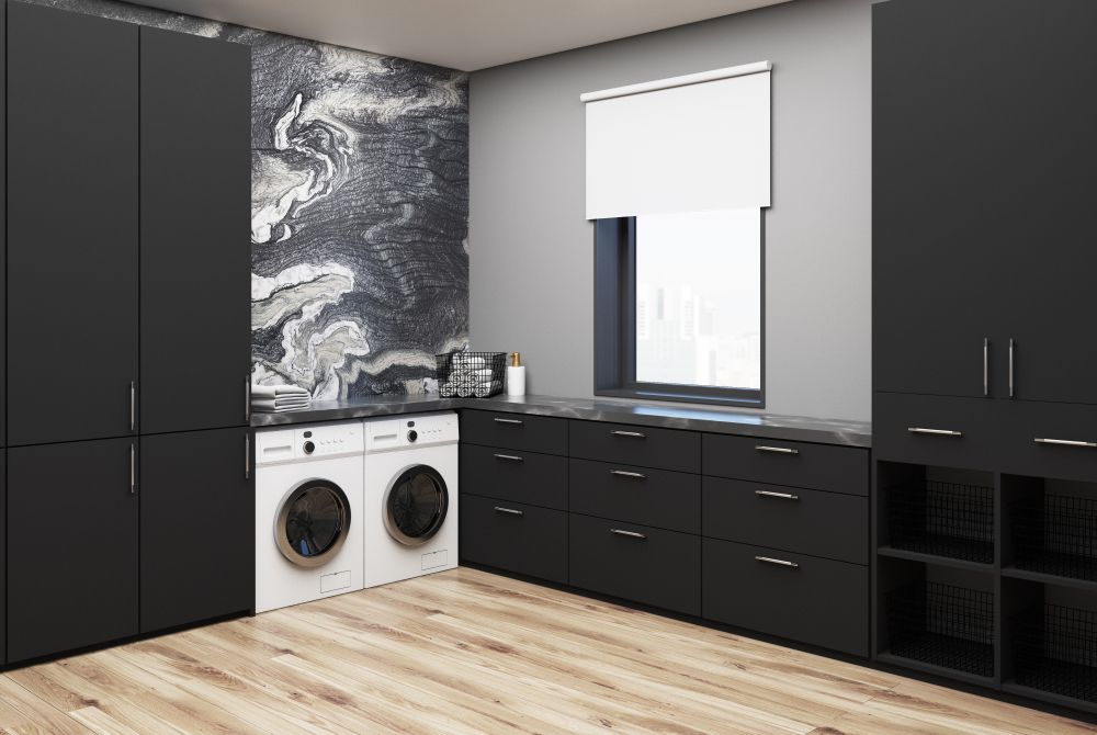 A Laundry Room With Black Cabinets , a Washer and Dryer , and a Window — Pacific Cabinets In Yamba, NSW