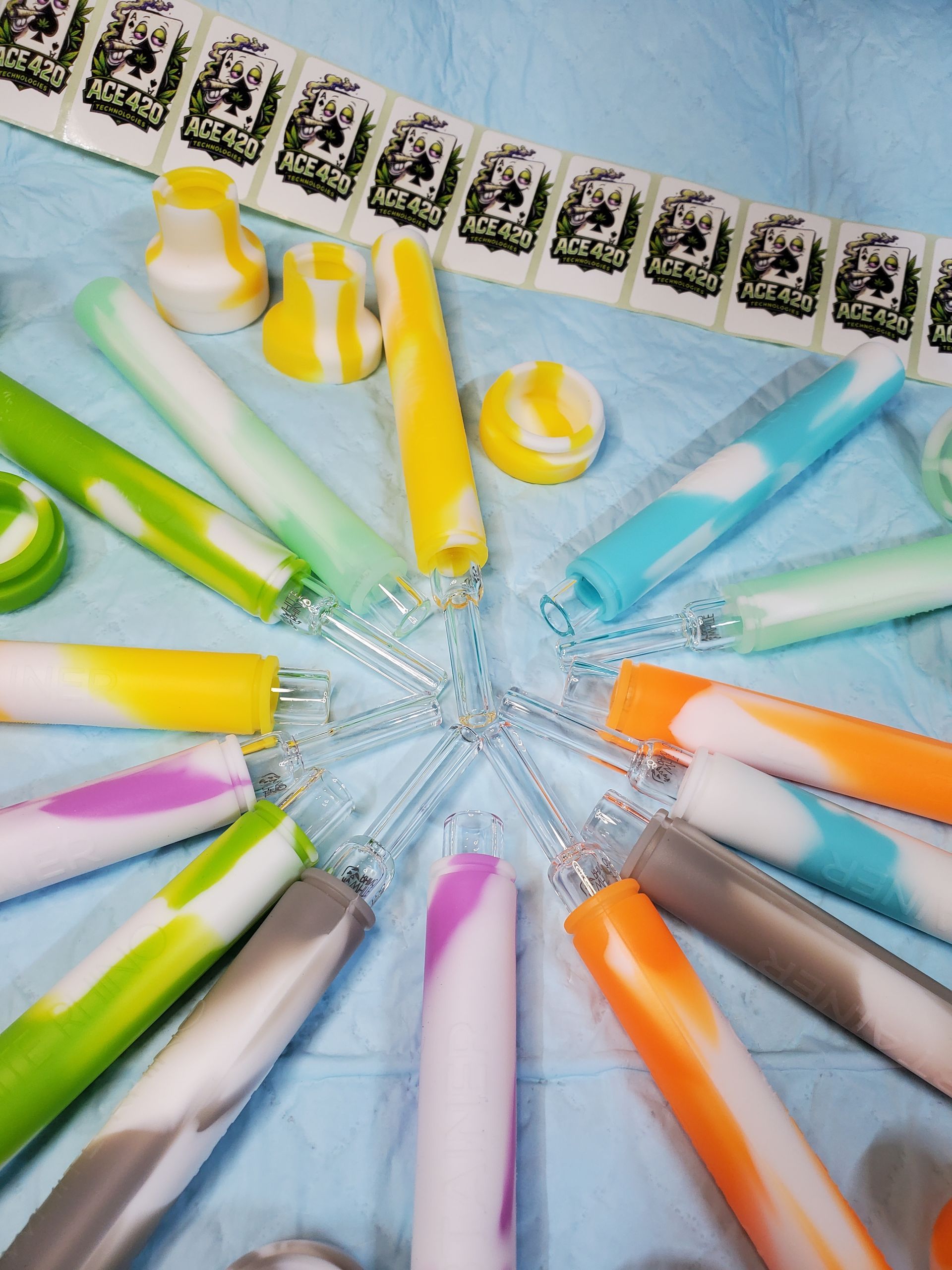 Colorful striped candles arranged in a circle on a blue surface, viewed from above