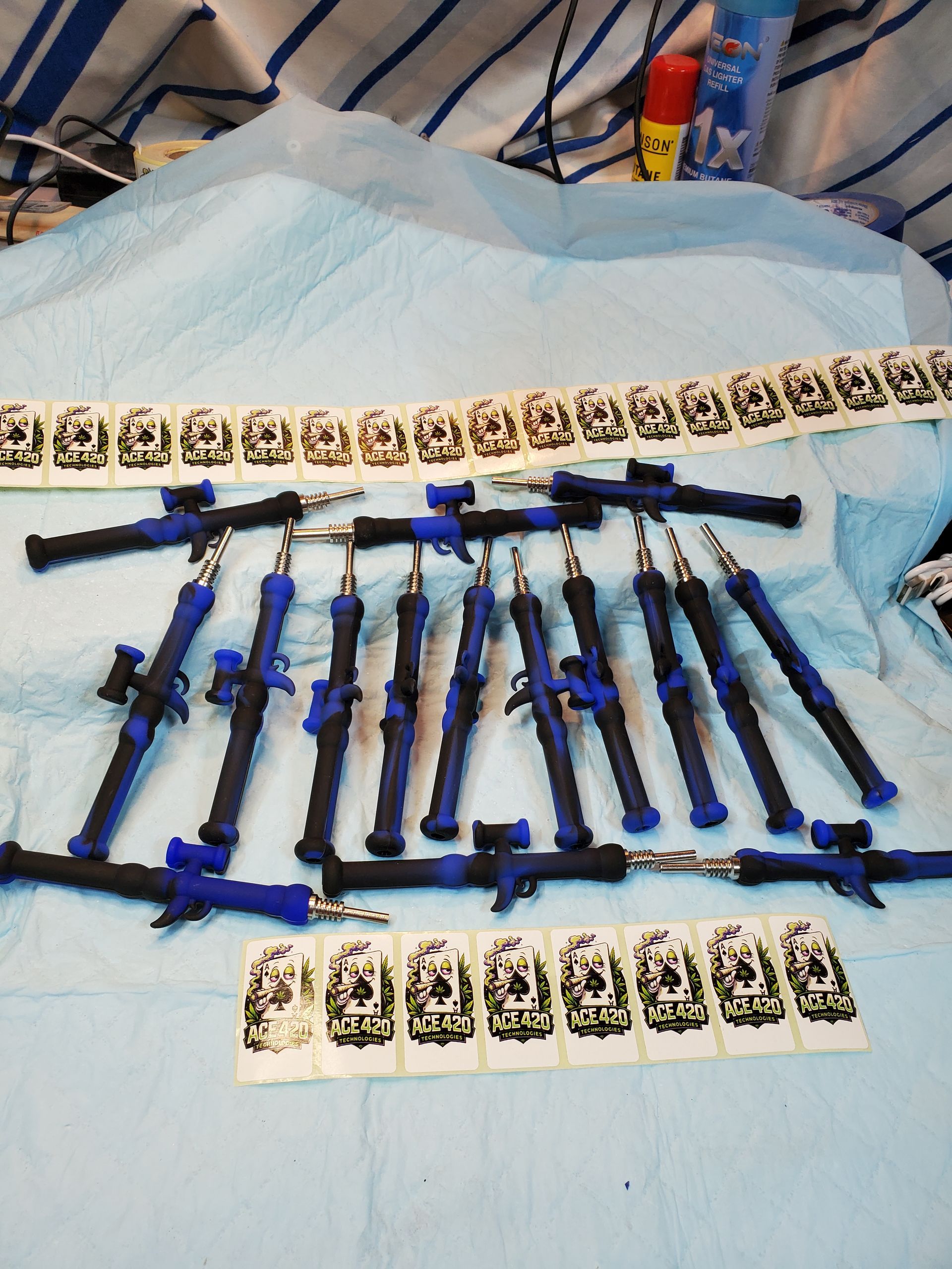 Assorted colorful toy swords and knives arranged on a bed with patterned cards above and below