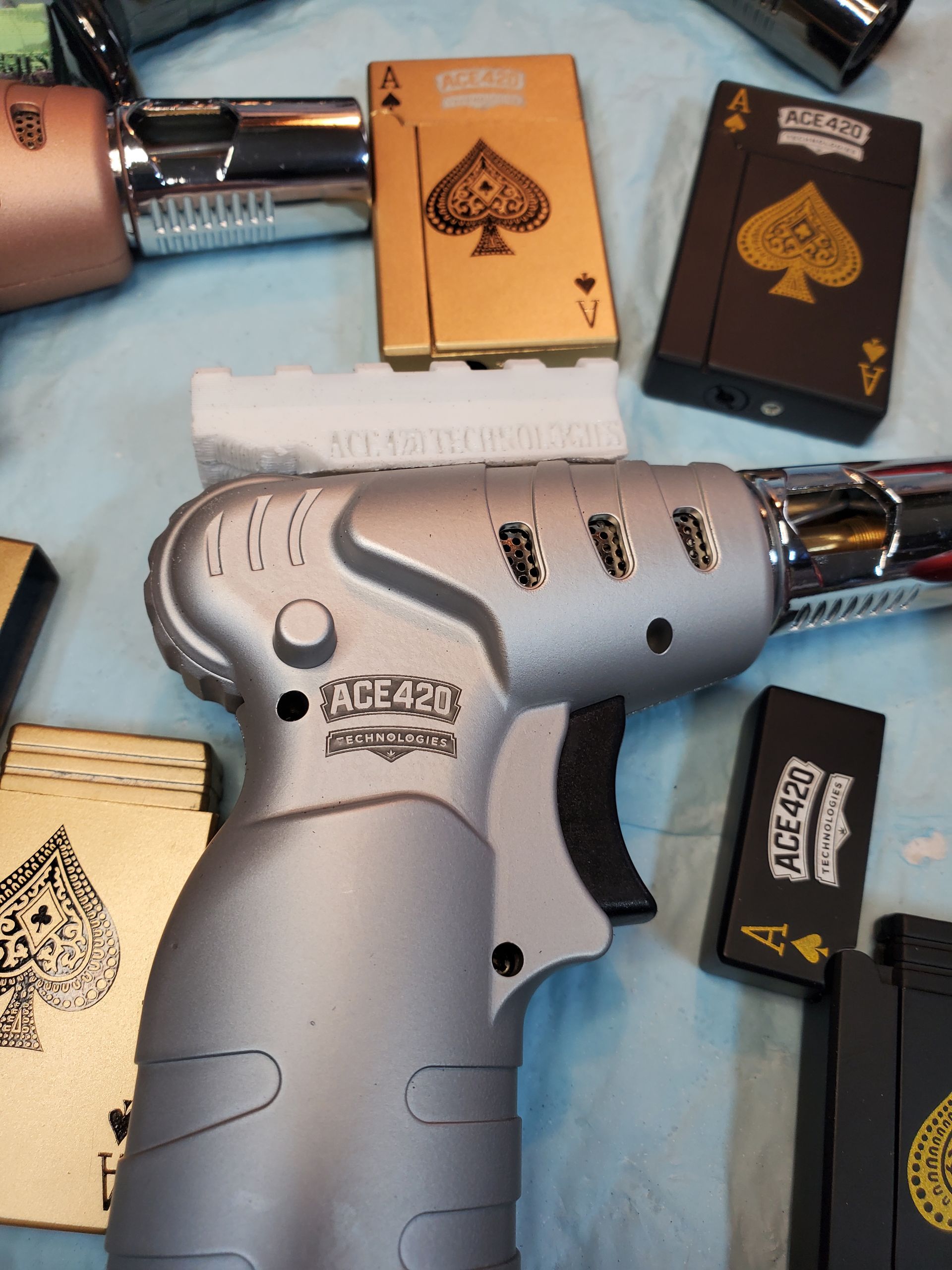 Silver-and-black handgun and other firearms arranged around a few playing cards on a surface