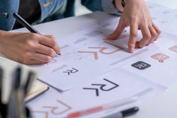 A Person Is Writing on A Piece of Paper with A Pen.