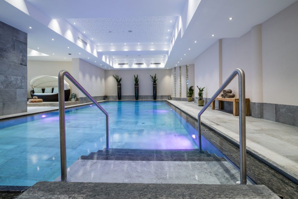 Ein großes Hallenbad mit Treppe in den Pool