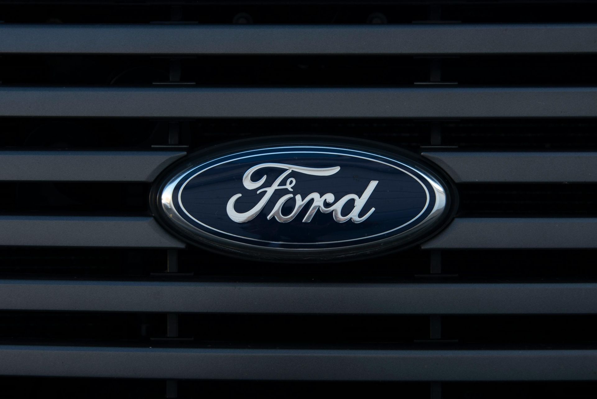 Ford logo emblem on a dark gray grill.